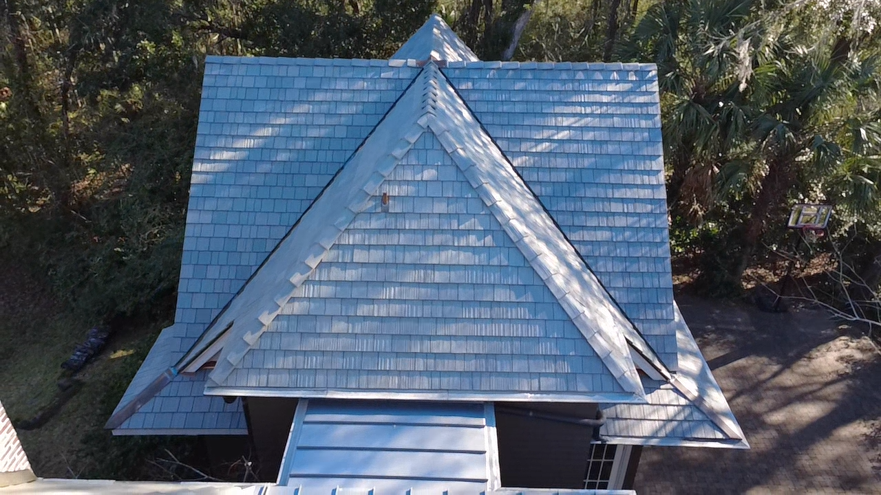 A house with a blue-toned shingle roof.