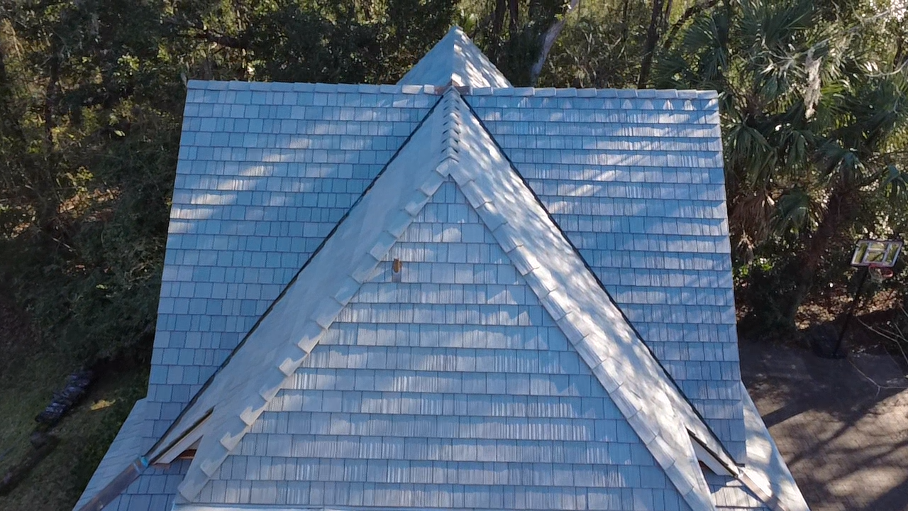 A house with a blue-toned shingle roof.