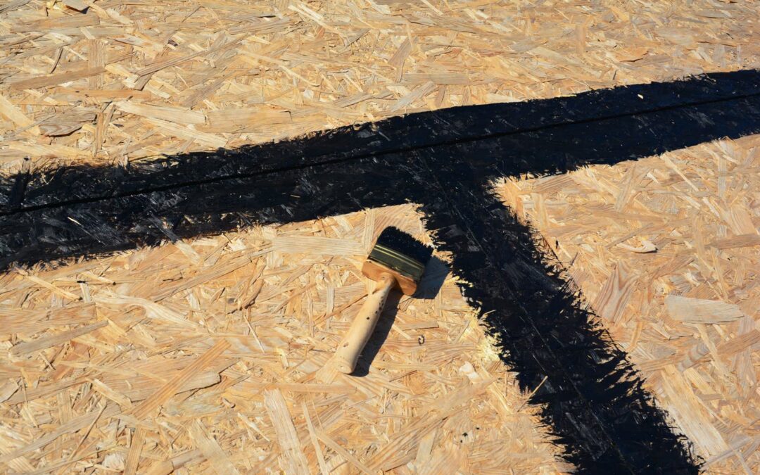 OSB roof deck with the seams between sheathing panels sealed in black bitumen before underlayment goes on